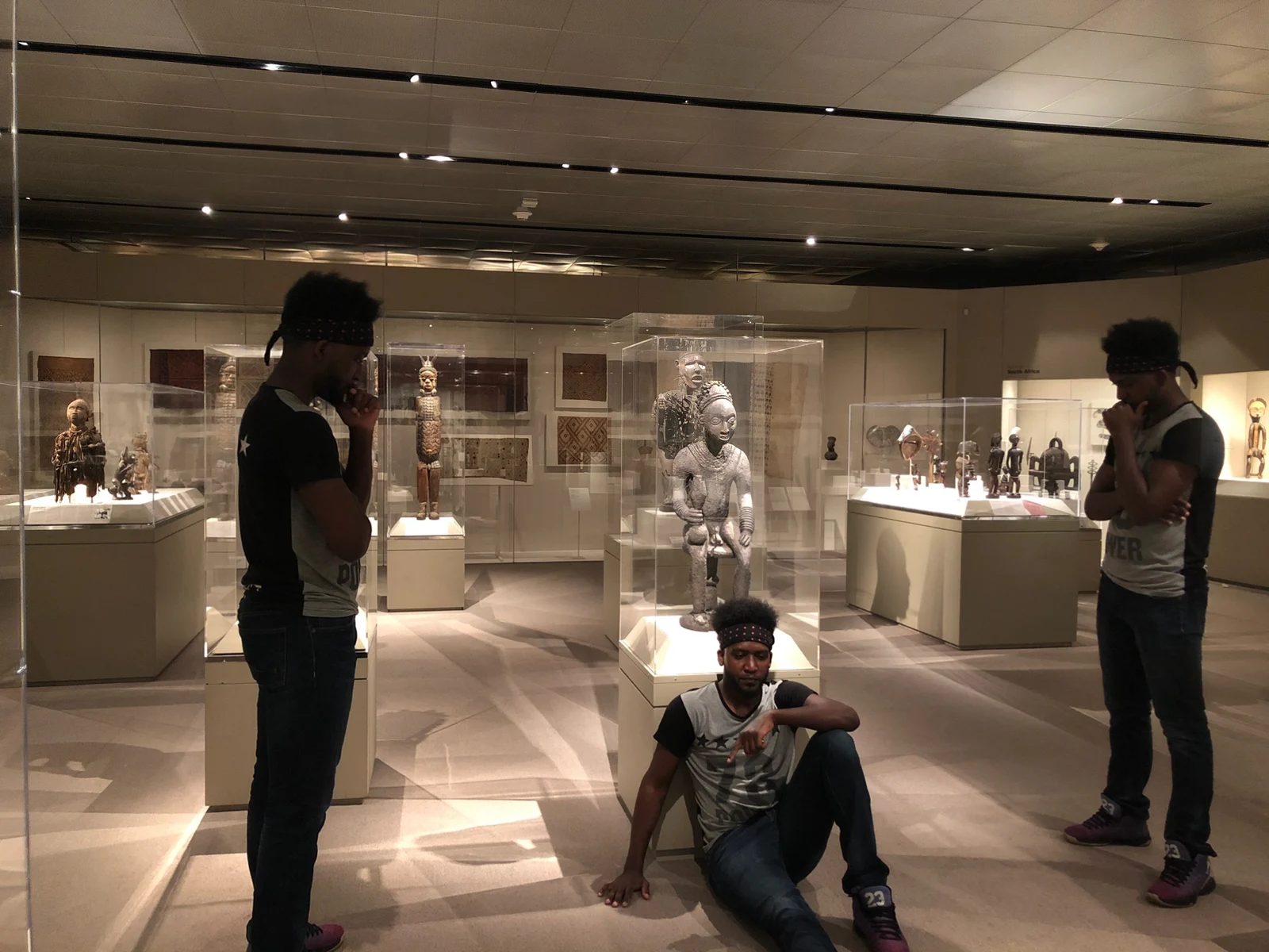 Friends among the sculptures of a museum gallery