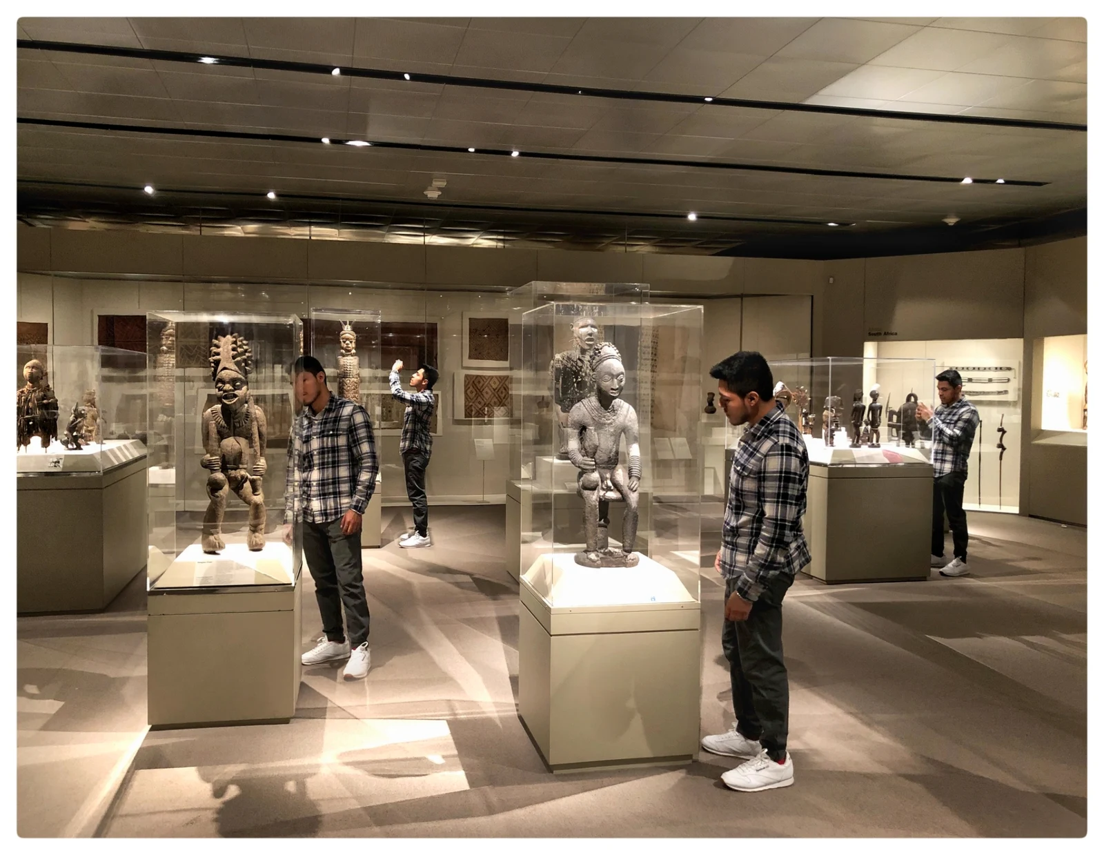 Layered multiple-exposure portrait repeating through a museum gallery