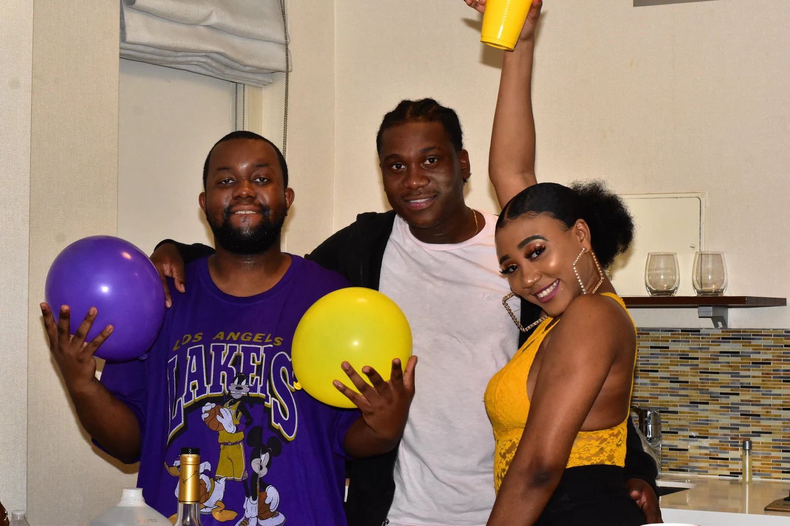 Friends celebrating among bright balloons at a party