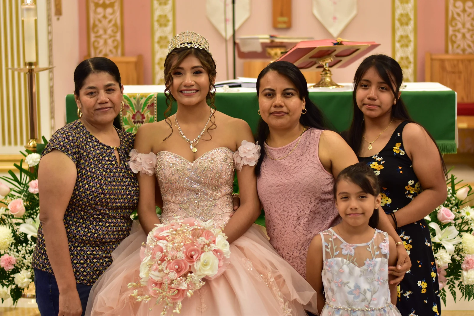 Quinceañera surrounded by her extended family