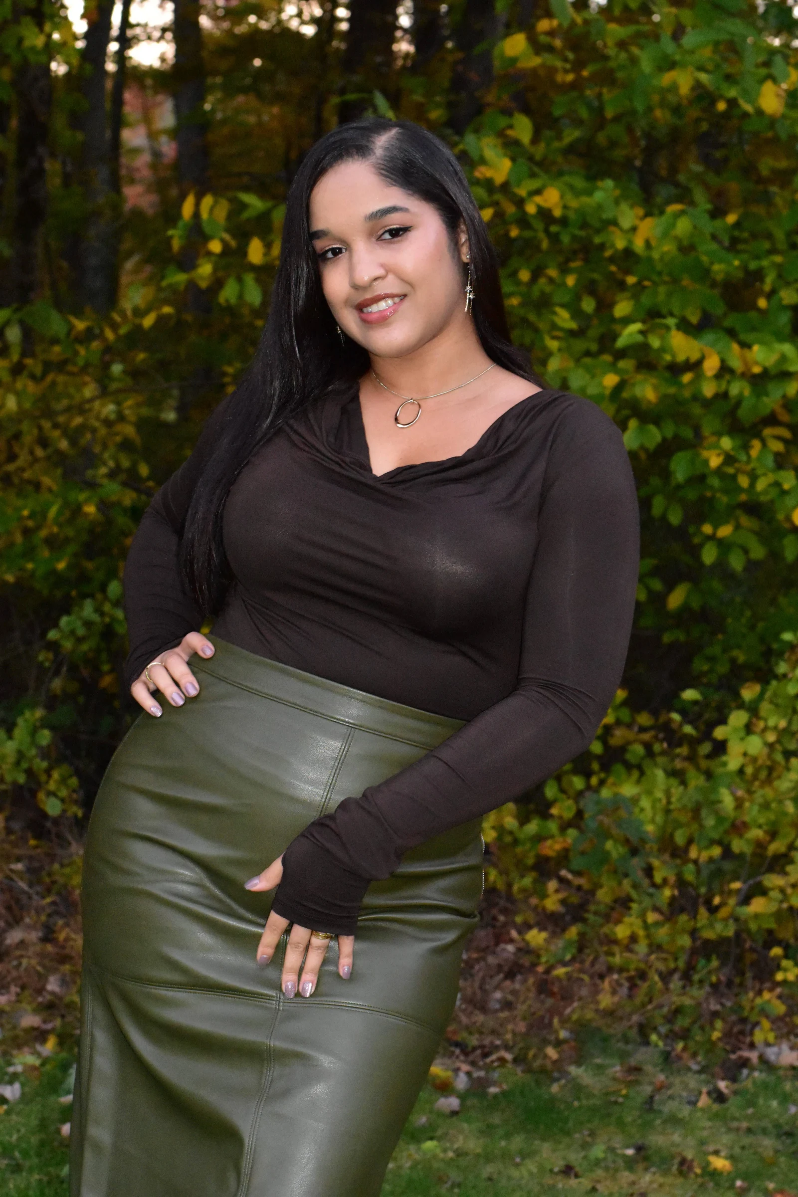 Portrait in an olive skirt against a backdrop of fall leaves