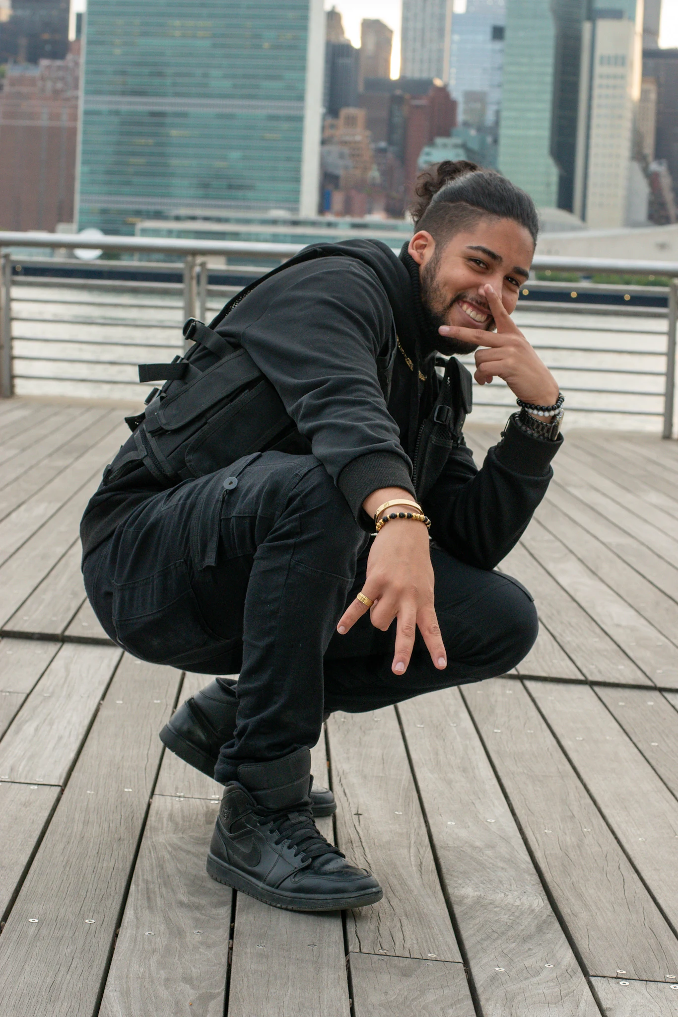 Portrait on a pier with the city skyline behind the subject
